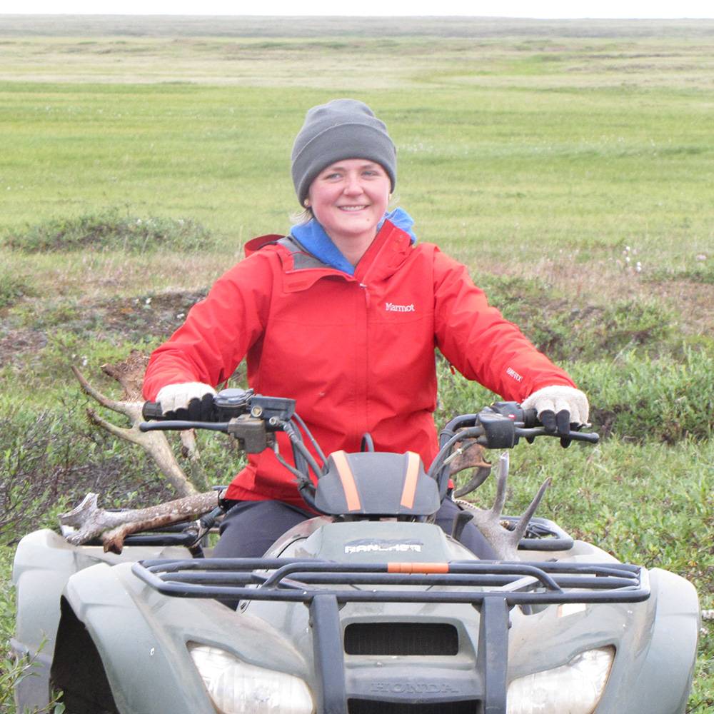 Sheila smiles from her ATV.